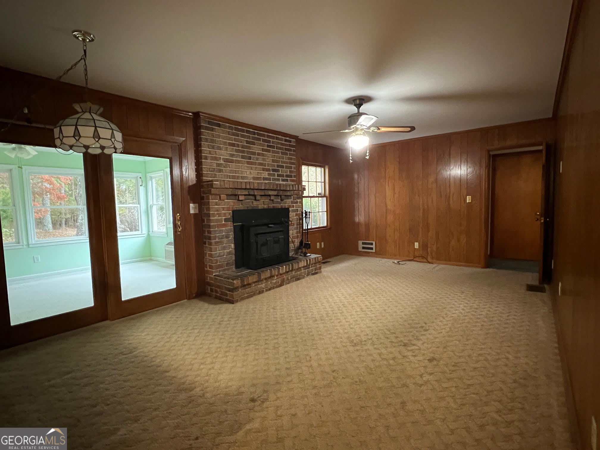 215 Old Oxford Road Covington, GA 30014 - Photo 14 of 19 an empty room with windows and fireplace