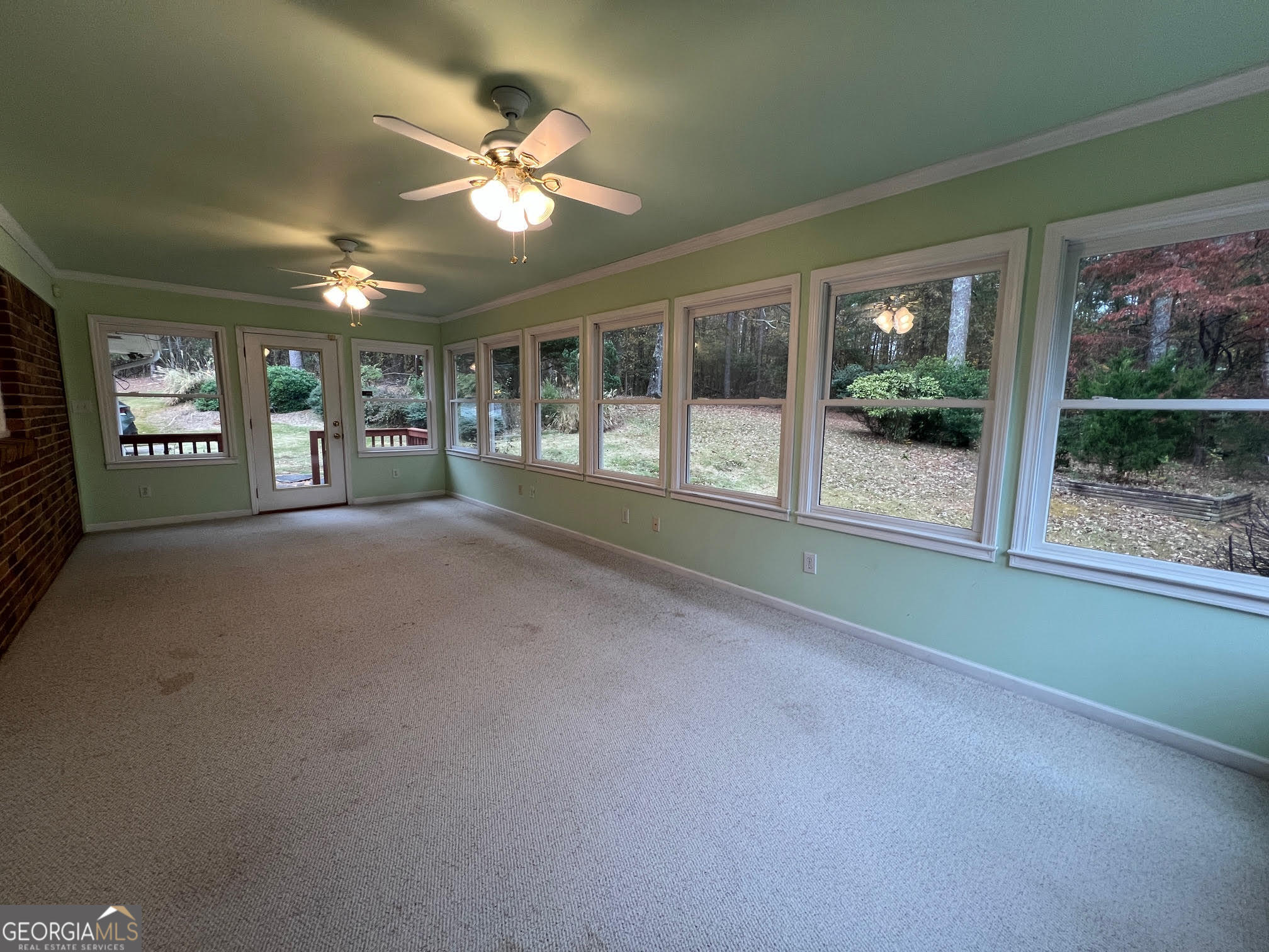 215 Old Oxford Road Covington, GA 30014 - Photo 17 of 19 a view of a livingroom with a ceiling fan and window