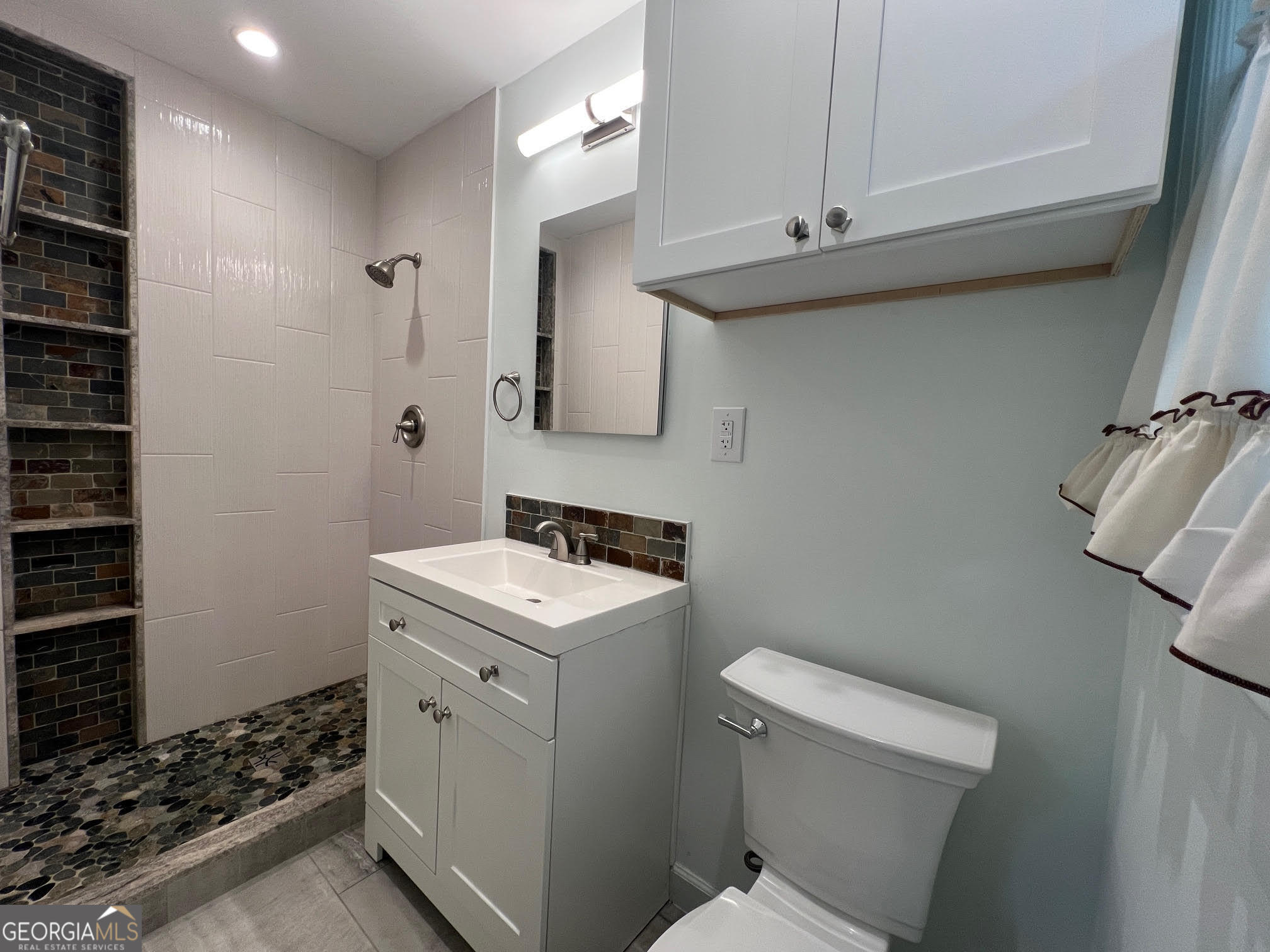 215 Old Oxford Road Covington, GA 30014 - Photo 19 of 19 a bathroom with a sink a toilet and shower