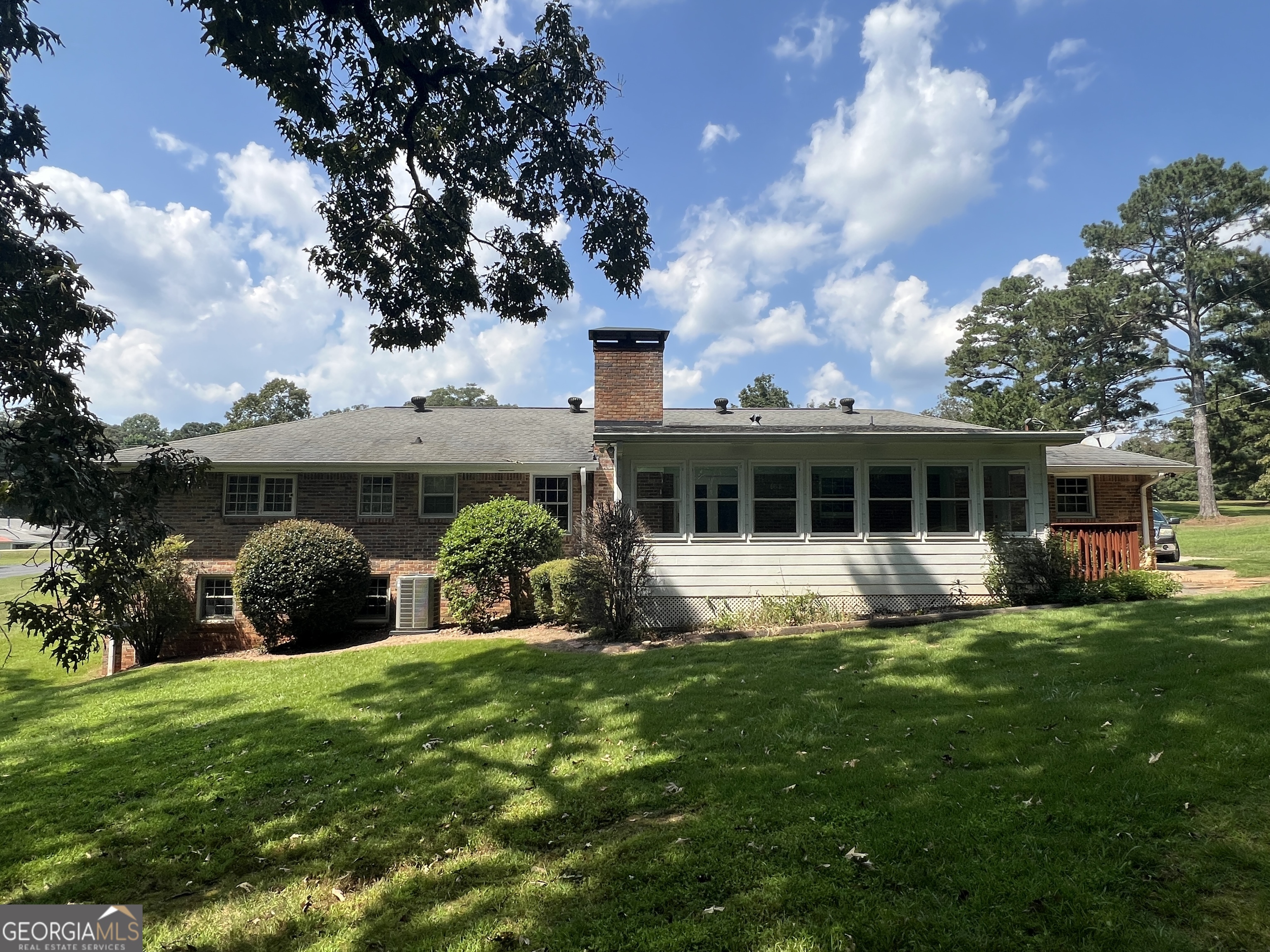 215 Old Oxford Road Covington, GA 30014 - Photo 3 of 19 a front view of a house with a yard table and chairs
