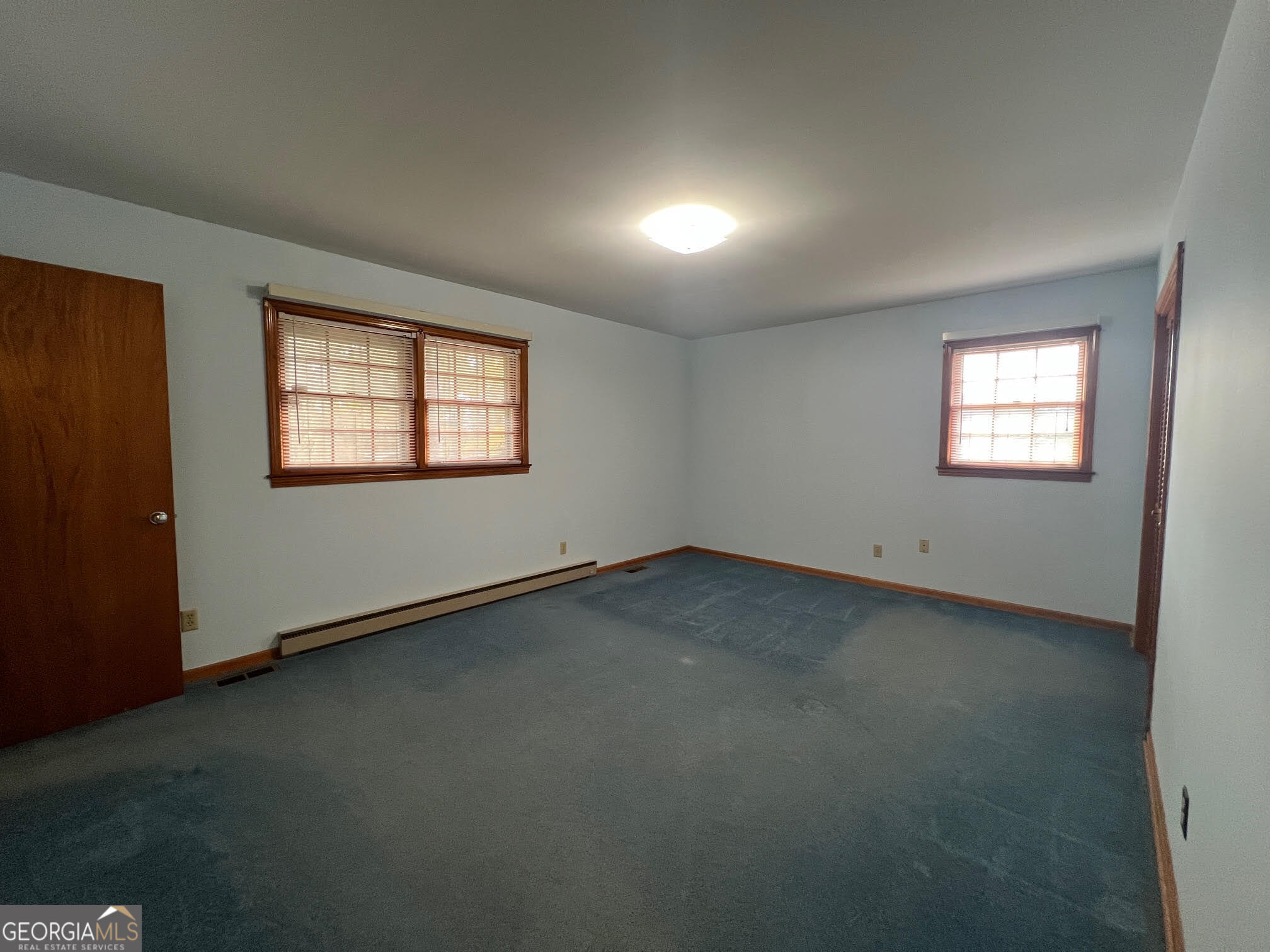 215 Old Oxford Road Covington, GA 30014 - Photo 5 of 19 an empty room with windows