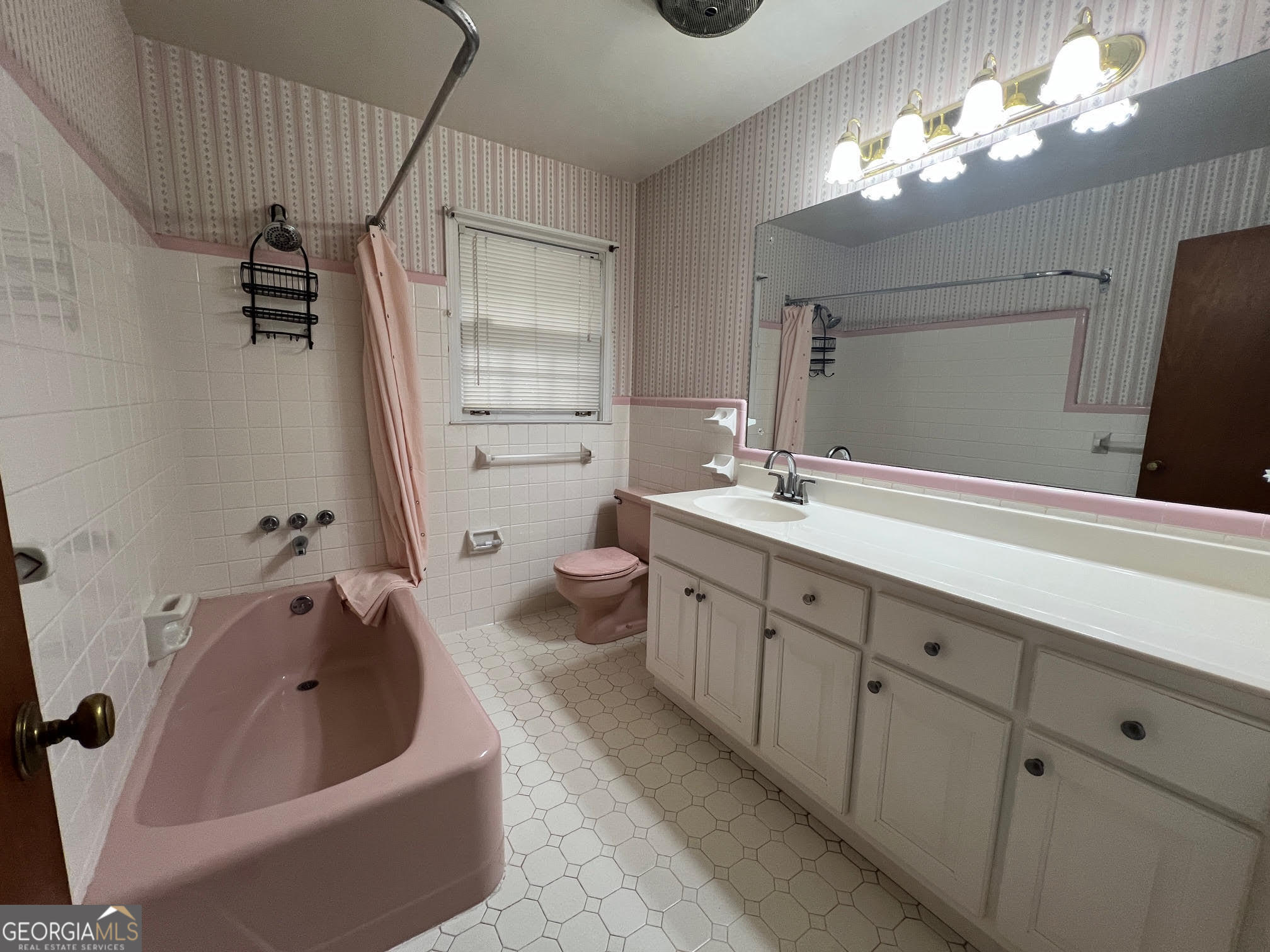 215 Old Oxford Road Covington, GA 30014 - Photo 9 of 19 a spacious bathroom with a double vanity sink a mirror and a bathtub
