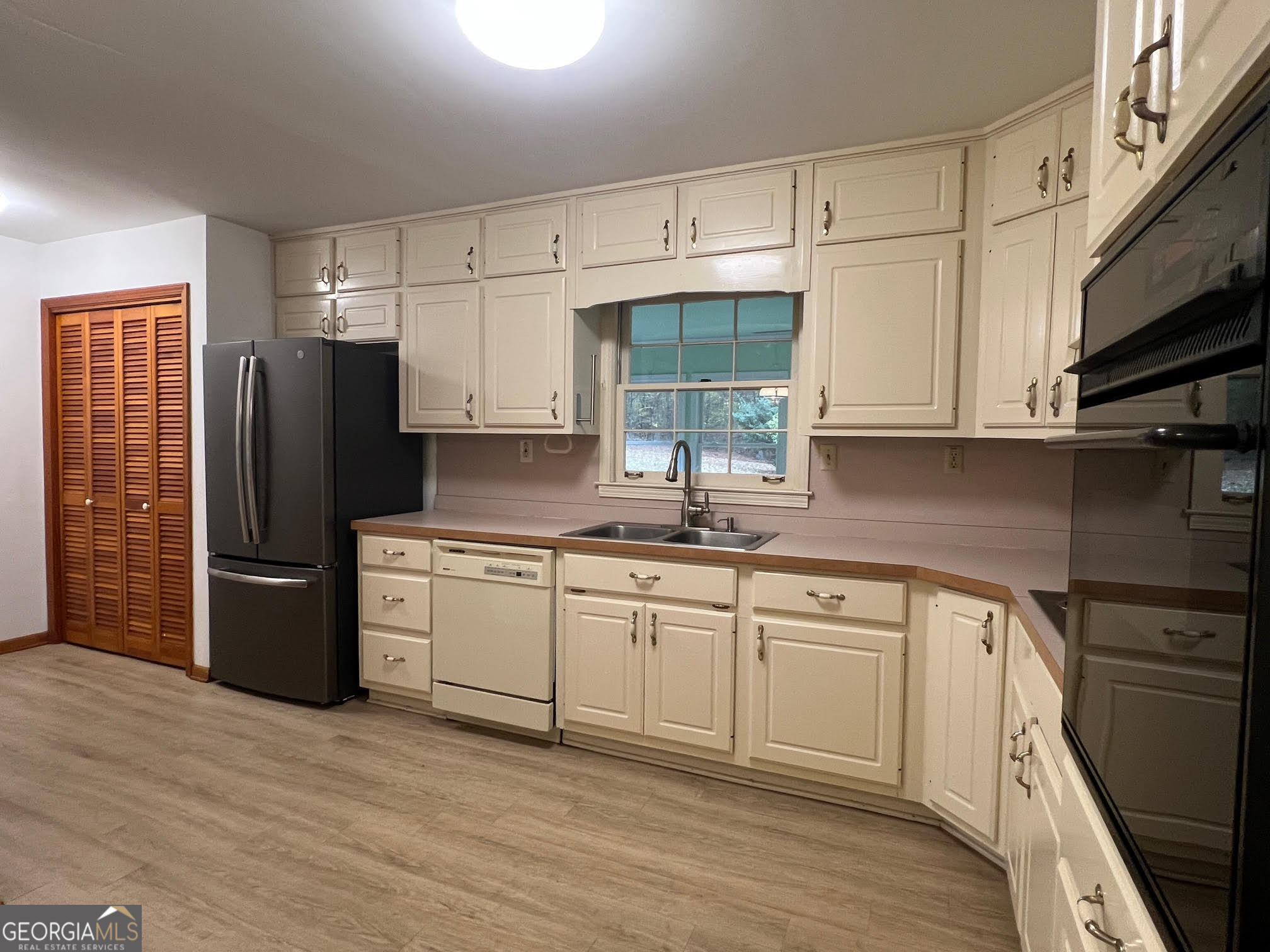 215 Old Oxford Road Covington, GA 30014 - Photo 10 of 19 a kitchen with a refrigerator sink and cabinets