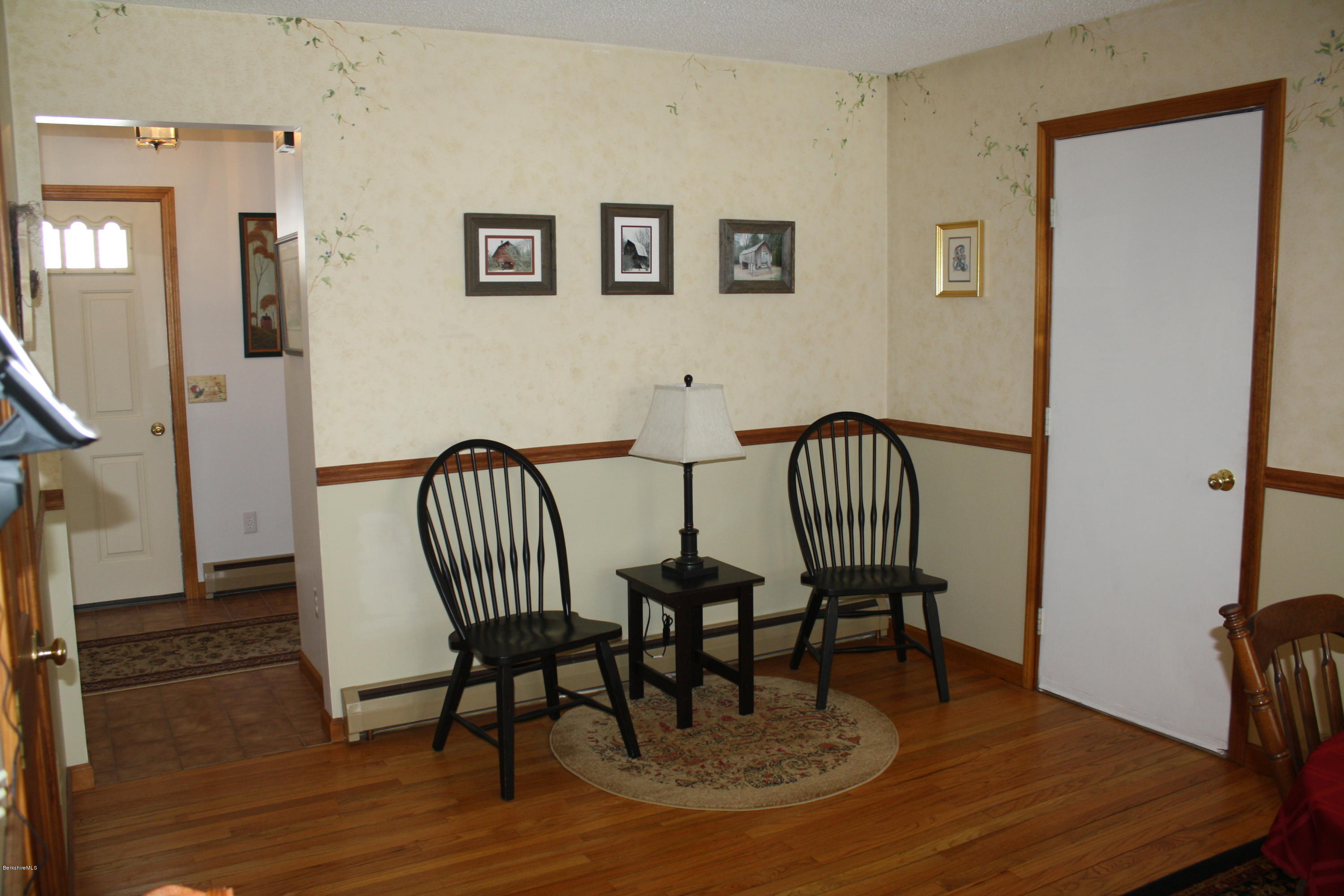 9 Quiet Knoll Road Stockbridge, MA 01266 - Photo 22 of 24 a view of a hallway with dining area a chandelier and wooden floor