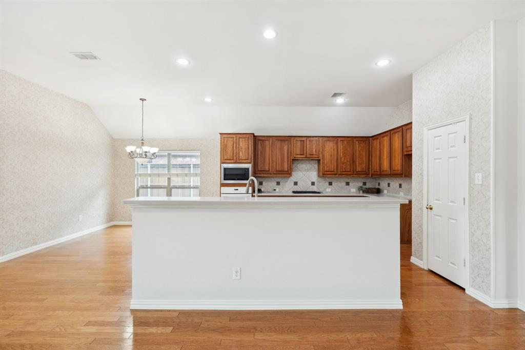 409 Fox Trail Allen, TX 75002 - Photo 12 of 31 a view of kitchen with stainless steel appliances granite countertop cabinets and wooden floor