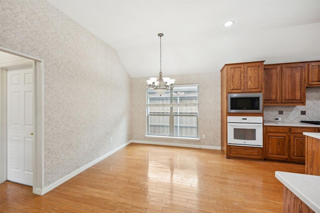 409 Fox Trail Allen, TX 75002 - Photo 15 of 31 a view of an empty room with a kitchen and a window
