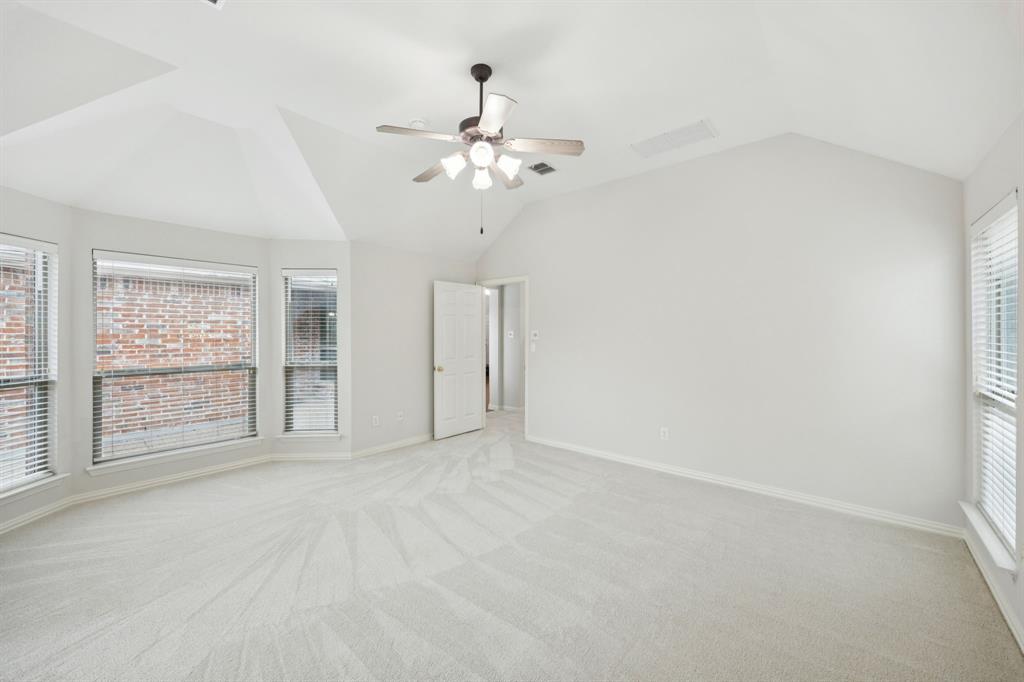 409 Fox Trail Allen, TX 75002 - Photo 16 of 31 an empty room with chandelier fan and windows