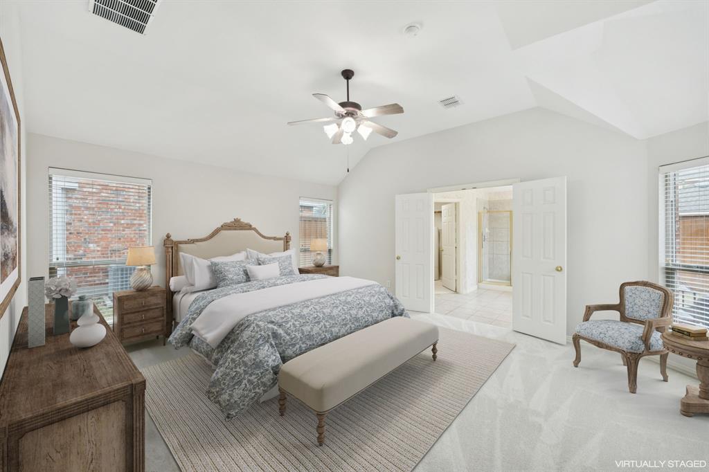 409 Fox Trail Allen, TX 75002 - Photo 17 of 31 a bedroom with a bed and a chandelier