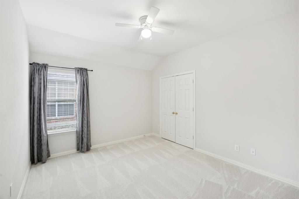 409 Fox Trail Allen, TX 75002 - Photo 24 of 31 an empty room with windows and fan