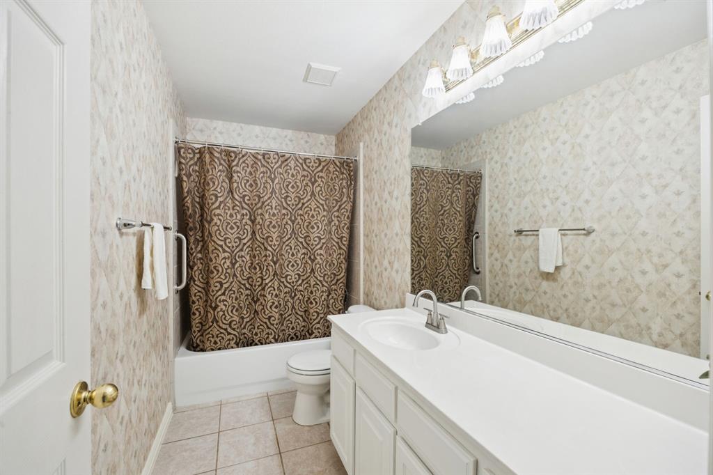 409 Fox Trail Allen, TX 75002 - Photo 26 of 31 a bathroom with a sink a toilet and shower