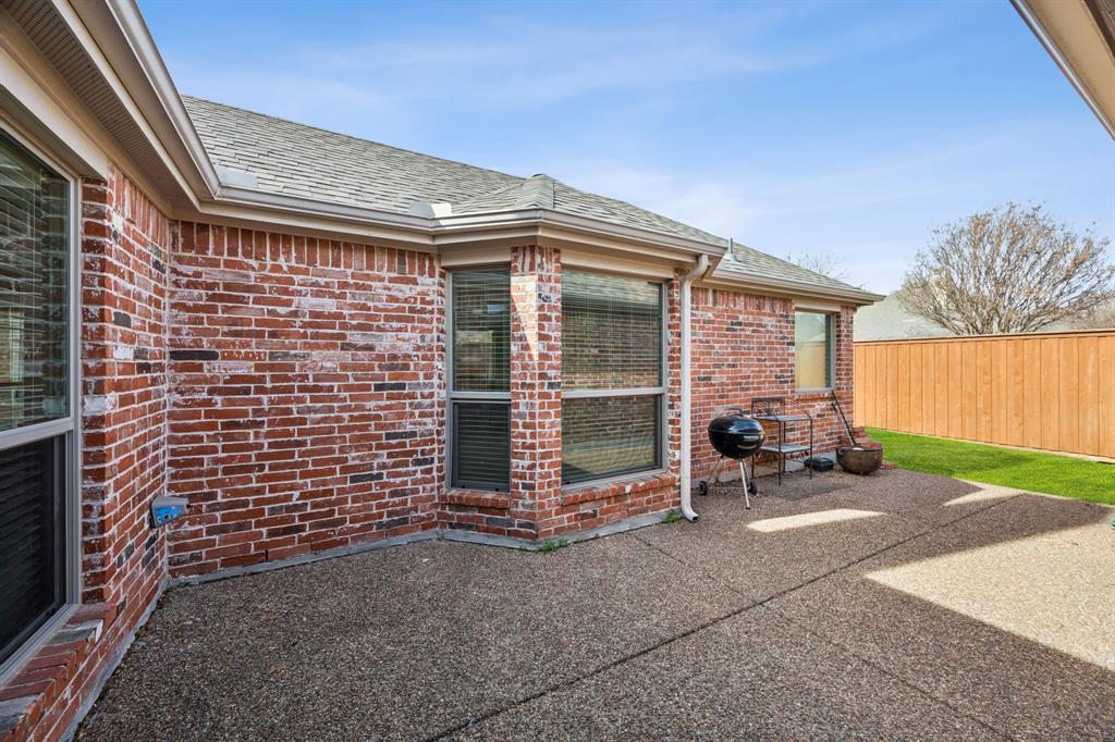 409 Fox Trail Allen, TX 75002 - Photo 28 of 31 a view of a patio with table and chairs and a barbeque