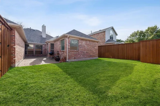 a view of a front of a house with a yard and garage