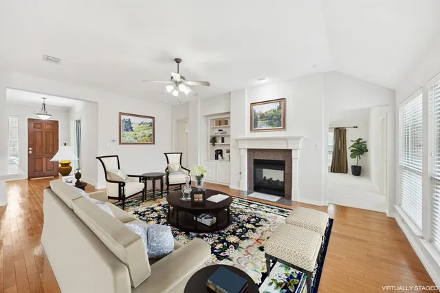a living room with furniture a fireplace and a table