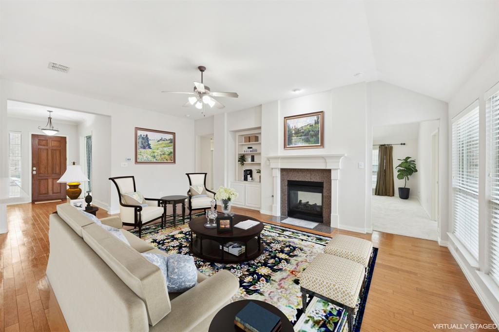 409 Fox Trail Allen, TX 75002 - Photo 6 of 31 a living room with furniture a fireplace and a table