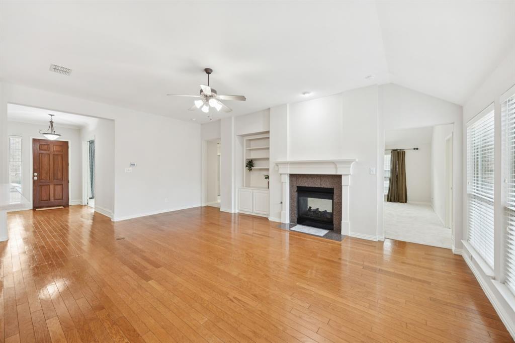 409 Fox Trail Allen, TX 75002 - Photo 7 of 31 a view of an empty room with a fireplace and a window