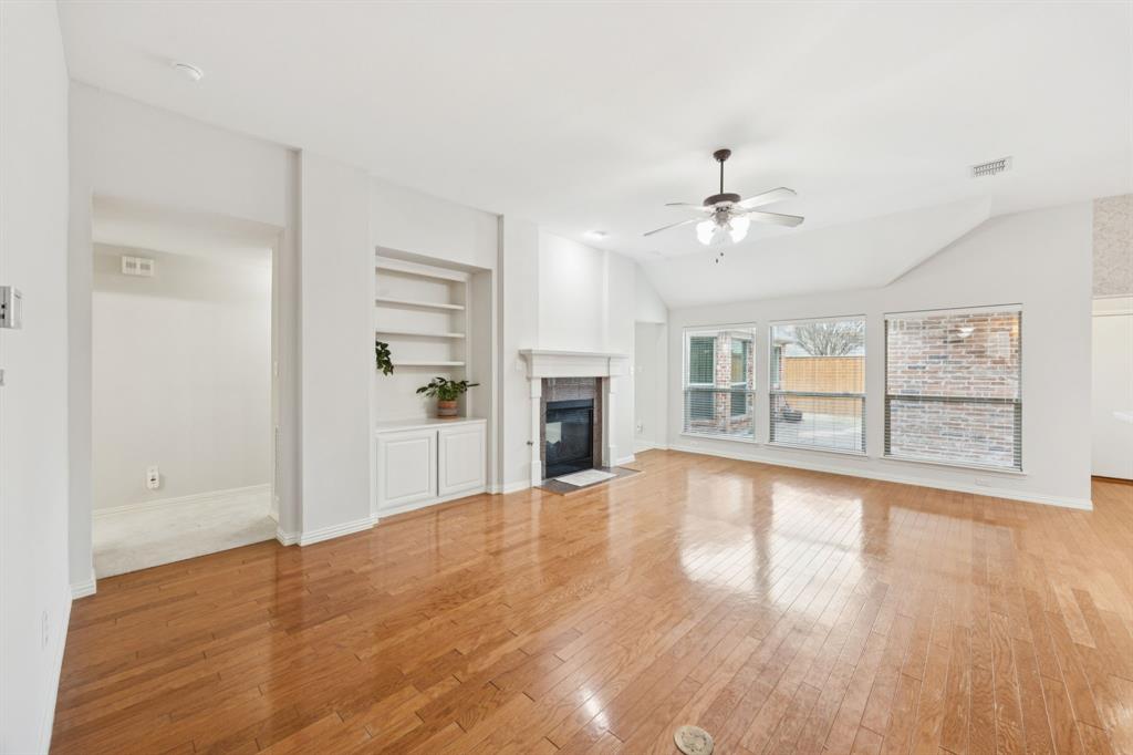 409 Fox Trail Allen, TX 75002 - Photo 8 of 31 a view of an empty room with a window and wooden floor
