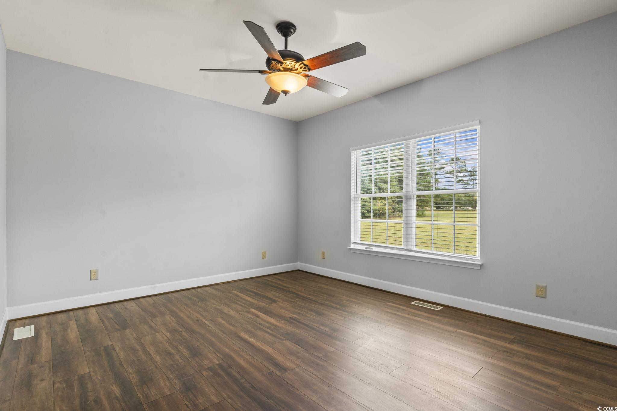 1585 Daisy Road Loris, SC 29569 - Photo 16 of 48 Unfurnished room with dark wood finished floors and a ceiling fan