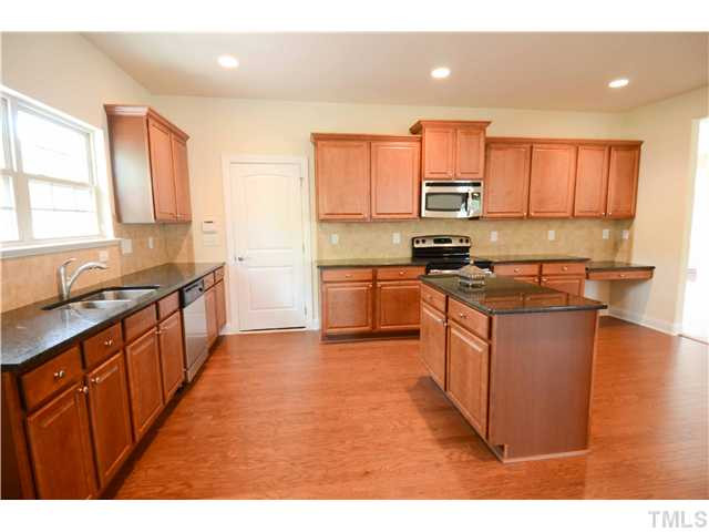 17 Spring Haven Lane Willow Spring, NC 27592 - Photo 15 of 22 Large Kitchen with Hardwoods, Designer Cabinets, Granite Countertops and so much more! Kitchen