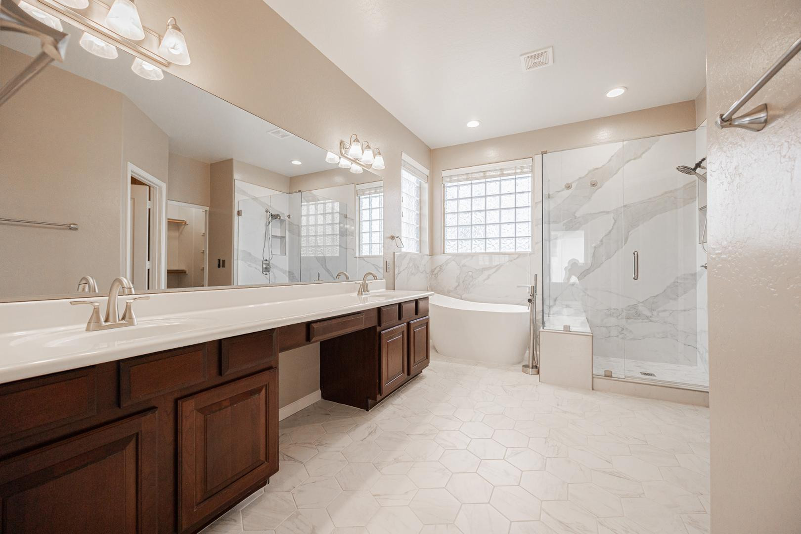 6539 West Jomax Road Phoenix, AZ 85083 - Photo 18 of 39 a large bathroom with a large tub sink vanity granite and a mirror
