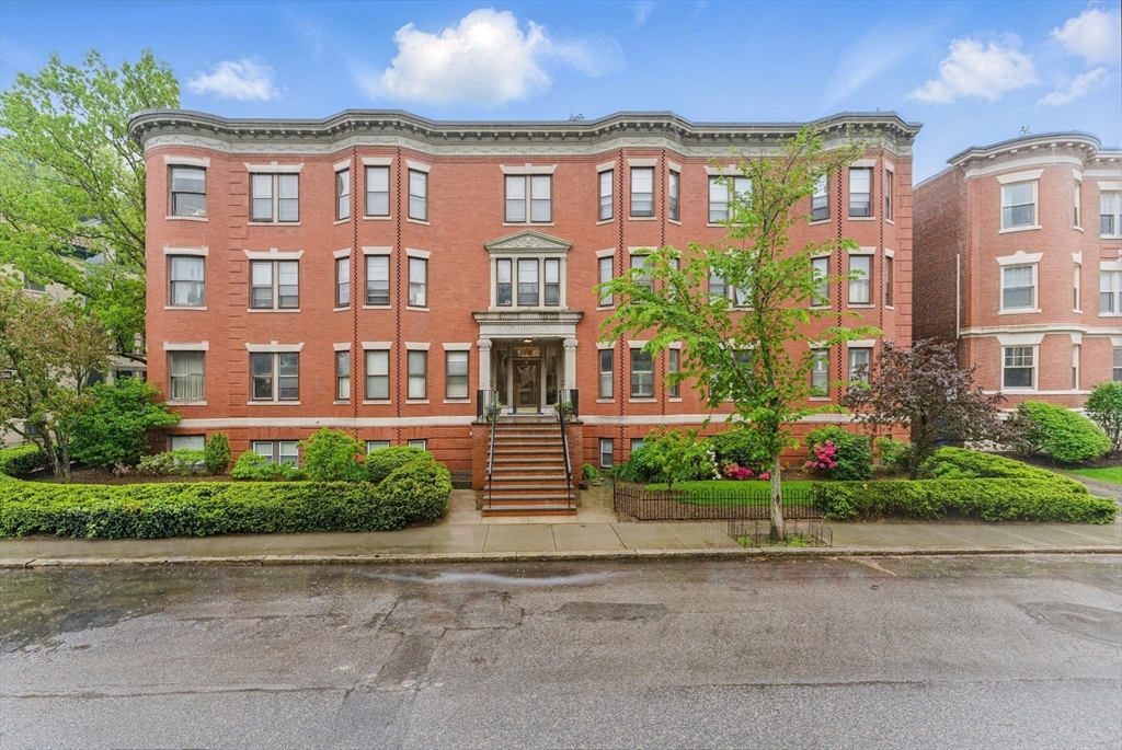 16 Garrison Road, Unit 7 Brookline, MA 02445 - Photo 1 of 33 a front view of a brick building next to a yard