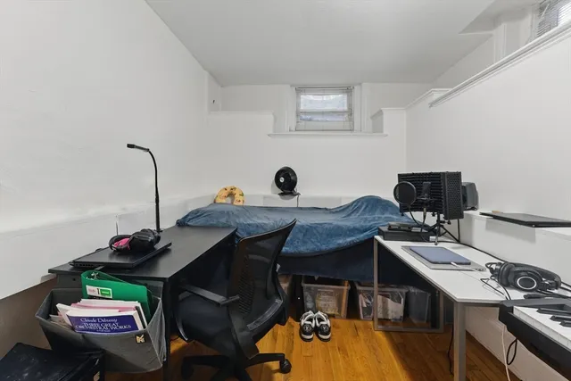 a view of a workspace with furniture and wooden floor