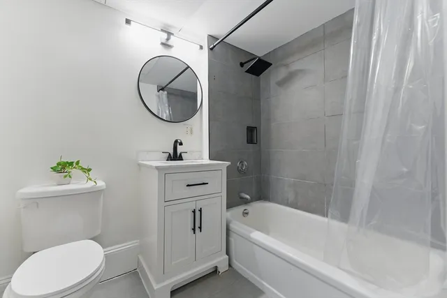 a bathroom with a sink a mirror a toilet and a bathtub