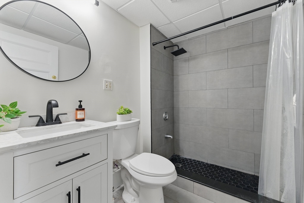 16 Garrison Road, Unit 7 Brookline, MA 02445 - Photo 26 of 33 a bathroom with a sink a toilet and a mirror
