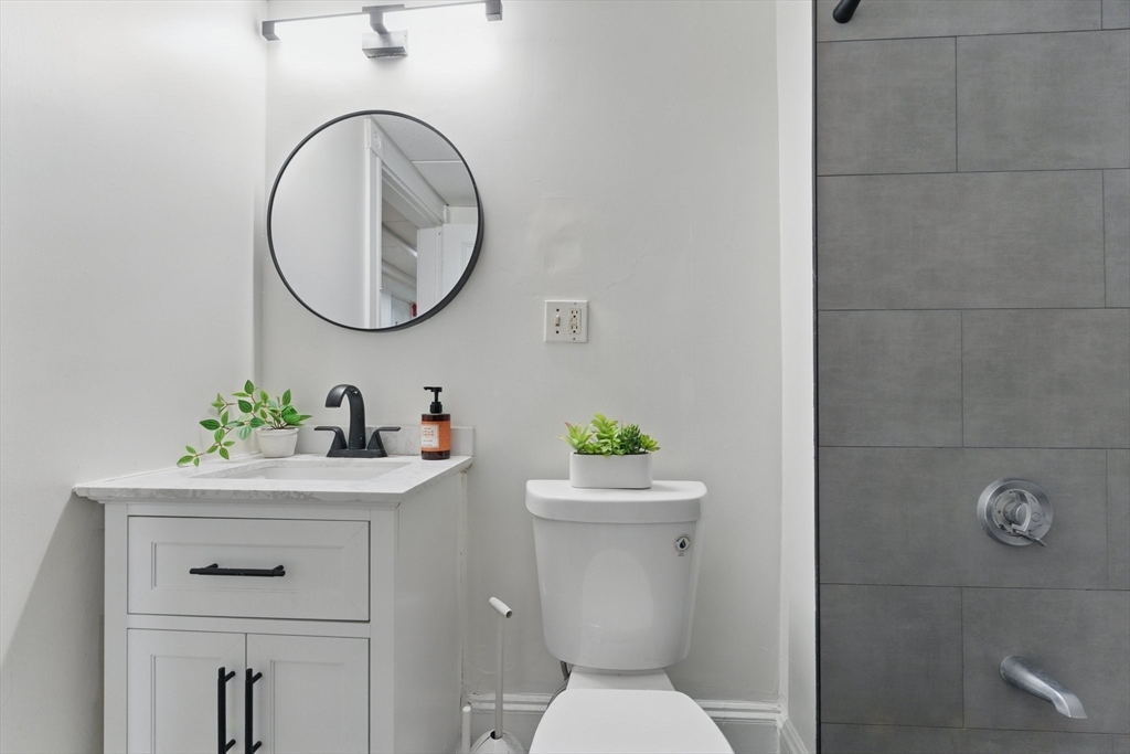 16 Garrison Road, Unit 7 Brookline, MA 02445 - Photo 27 of 33 a bathroom with a sink a toilet and a mirror