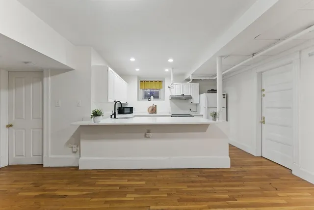 a kitchen with granite countertop a sink and cabinets