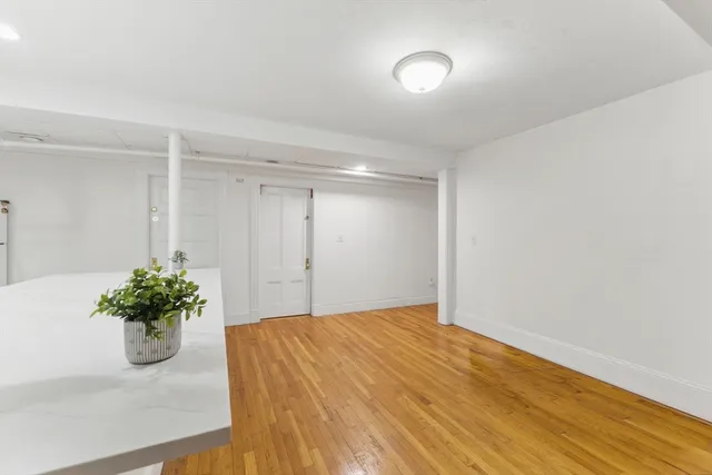 a view of kitchen with wooden floor and stainless steel appliances