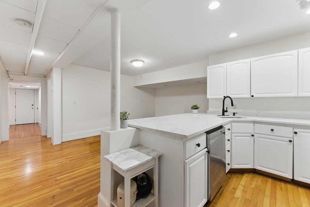 16 Garrison Road, Unit 7 Brookline, MA 02445 - Photo 10 of 33 a kitchen with a sink and wooden floor
