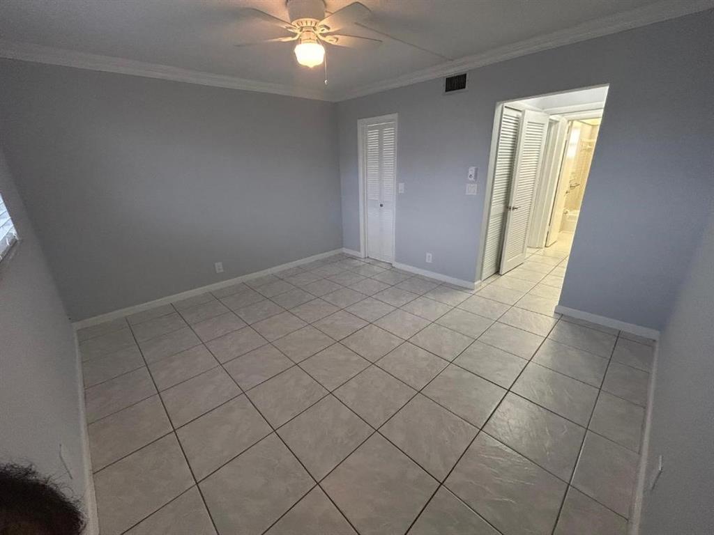 1310 Northwest 43rd Avenue, Unit 303 Lauderhill, FL 33313 - Photo 11 of 15 an empty room with windows