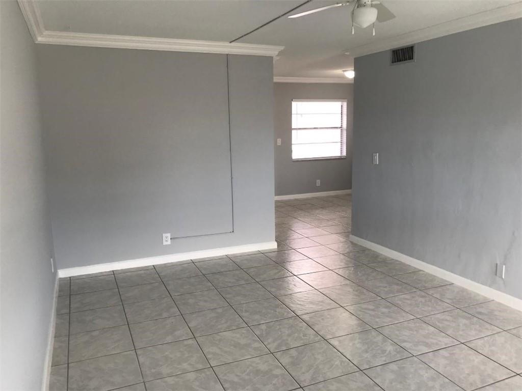 1310 Northwest 43rd Avenue, Unit 303 Lauderhill, FL 33313 - Photo 4 of 15 an empty room with windows