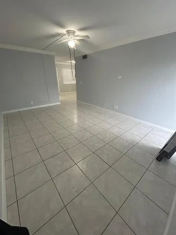 a view of a livingroom and chandelier fan