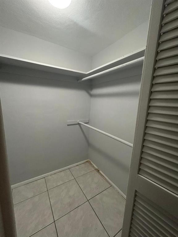 1310 Northwest 43rd Avenue, Unit 303 Lauderhill, FL 33313 - Photo 8 of 15 a view of a room with racks on the wall