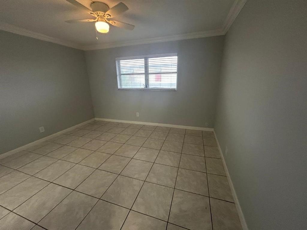 1310 Northwest 43rd Avenue, Unit 303 Lauderhill, FL 33313 - Photo 10 of 15 an empty room with windows and fan