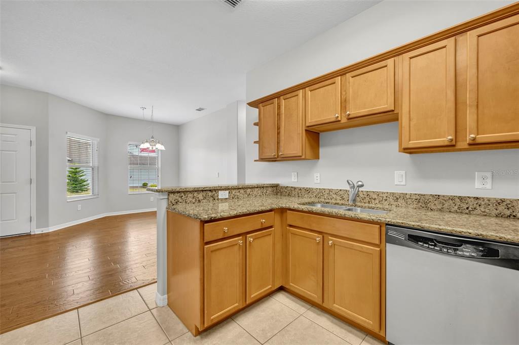 3201 Sonesta Court, Unit A Clermont, FL 34711 - Photo 11 of 34 a kitchen with stainless steel appliances granite countertop a sink stove and cabinets