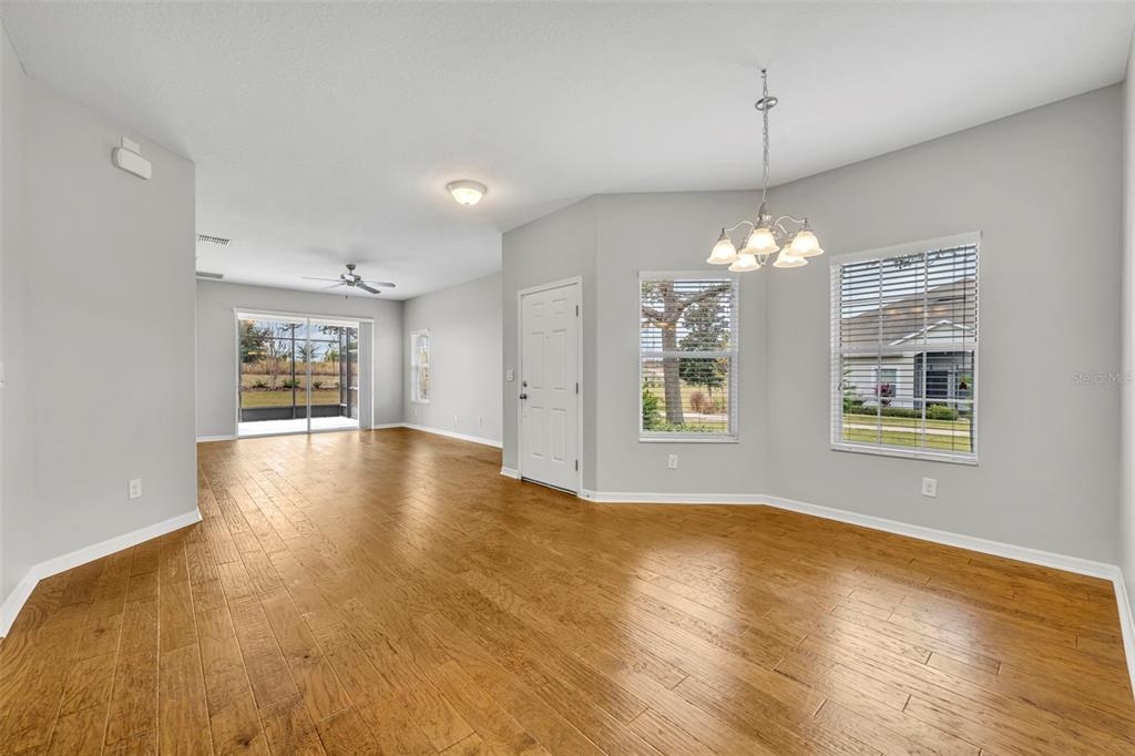 3201 Sonesta Court, Unit A Clermont, FL 34711 - Photo 16 of 34 a view of an empty room with window and wooden floor