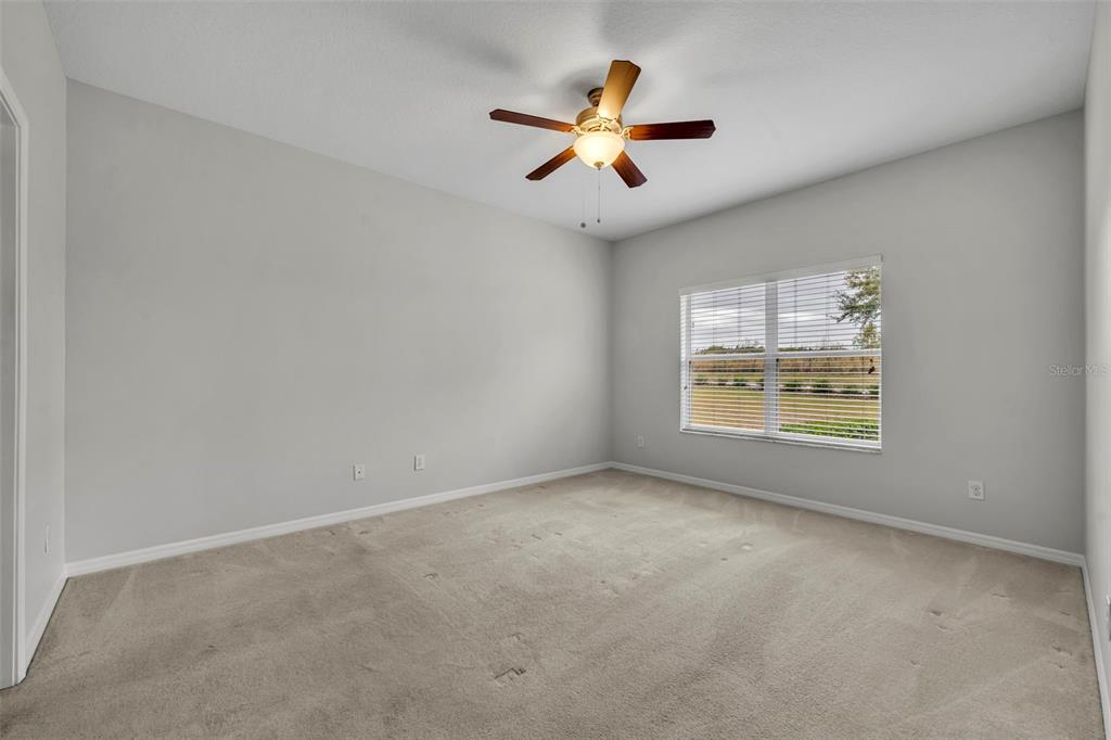 3201 Sonesta Court, Unit A Clermont, FL 34711 - Photo 22 of 34 an empty room with window and ceiling fan