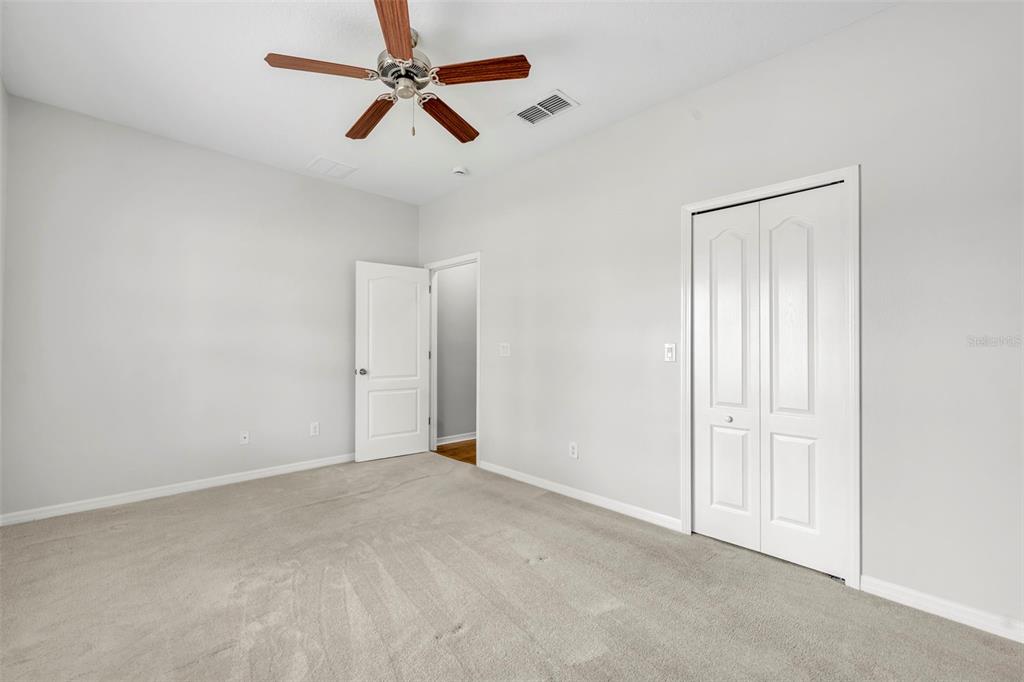3201 Sonesta Court, Unit A Clermont, FL 34711 - Photo 27 of 34 an empty room with closet and fan