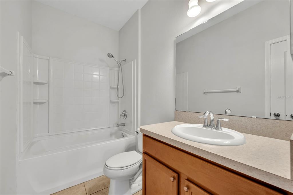 3201 Sonesta Court, Unit A Clermont, FL 34711 - Photo 28 of 34 a bathroom with a sink toilet and shower