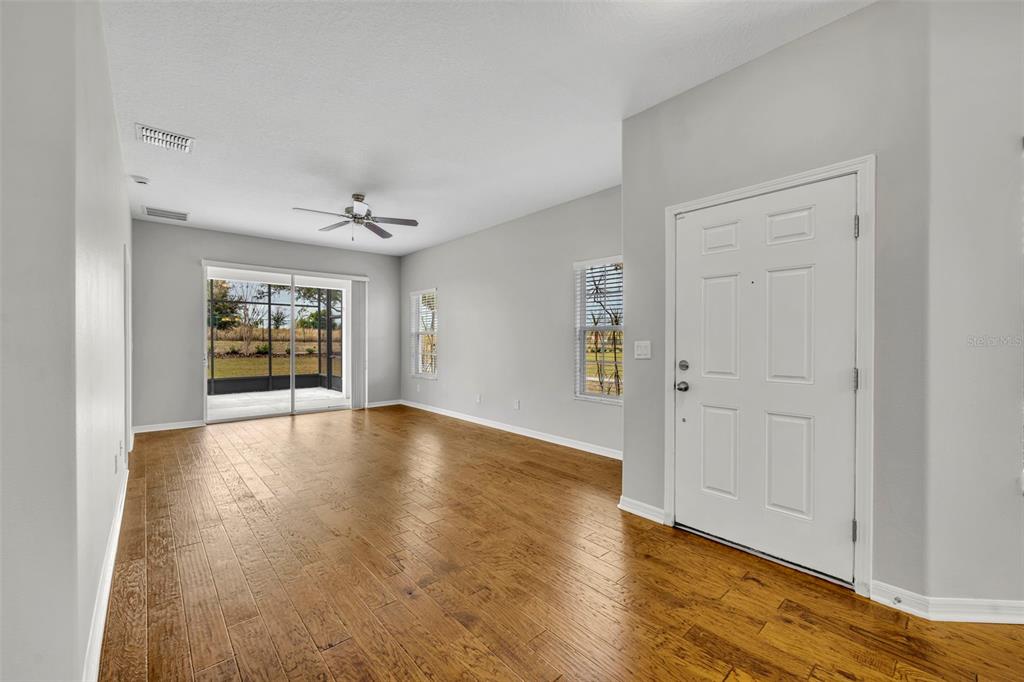 3201 Sonesta Court, Unit A Clermont, FL 34711 - Photo 4 of 34 a view of an empty room with window and wooden floor
