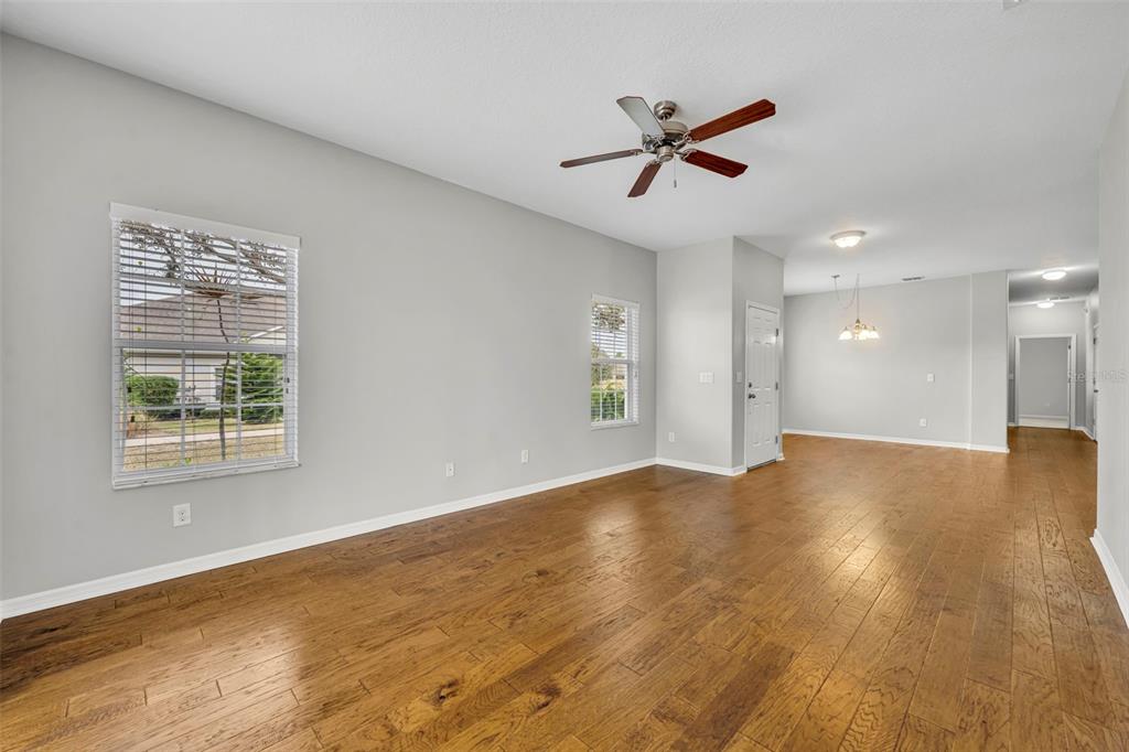 3201 Sonesta Court, Unit A Clermont, FL 34711 - Photo 7 of 34 a view of a livingroom with a ceiling fan & wooden floor