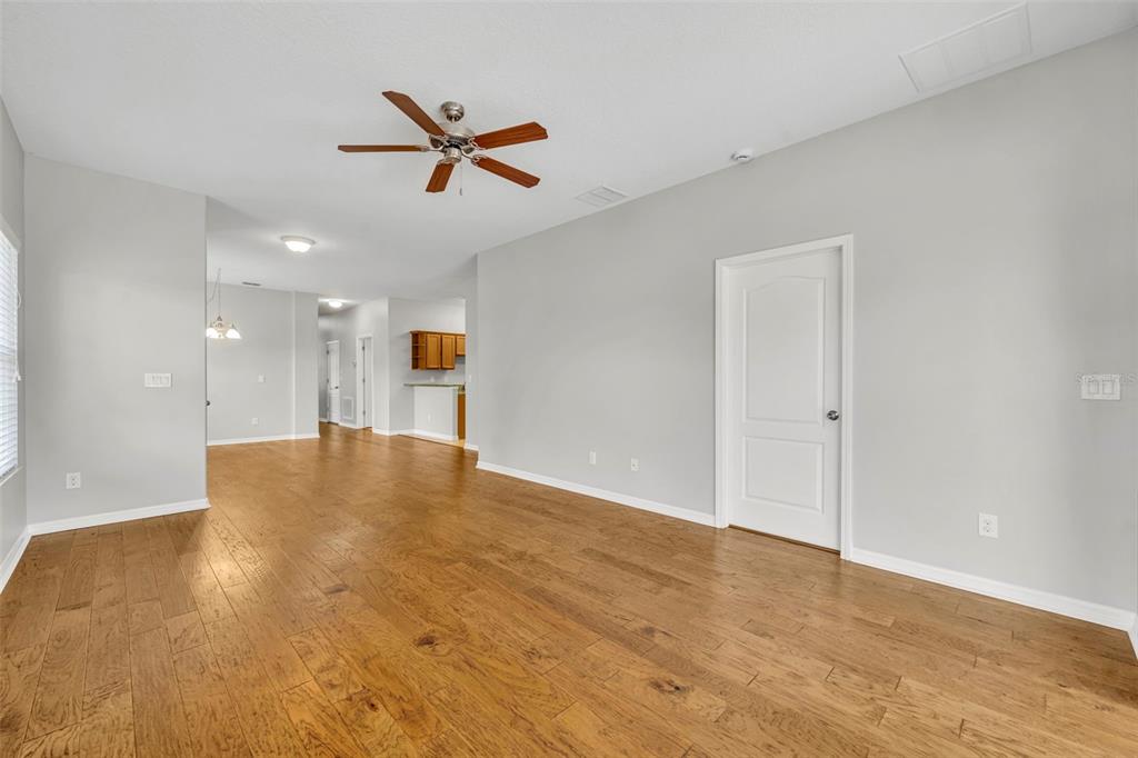 3201 Sonesta Court, Unit A Clermont, FL 34711 - Photo 8 of 34 a view of a livingroom with a ceiling fan and wooden floor