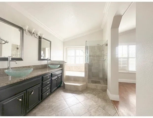 a bathroom with a granite countertop sink mirror and