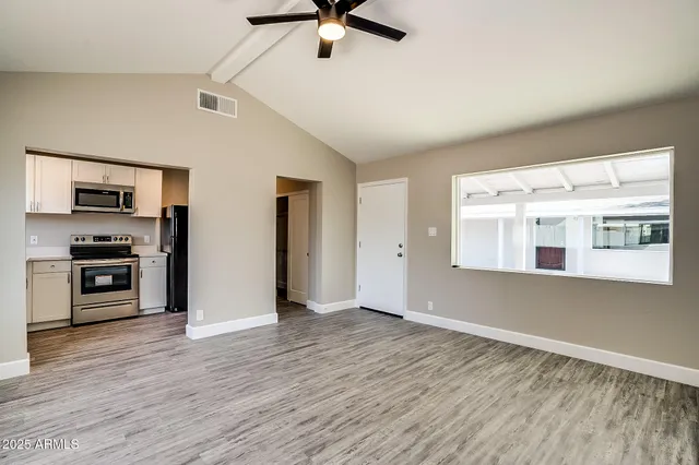a kitchen with white cabinets and stainless steel appliances