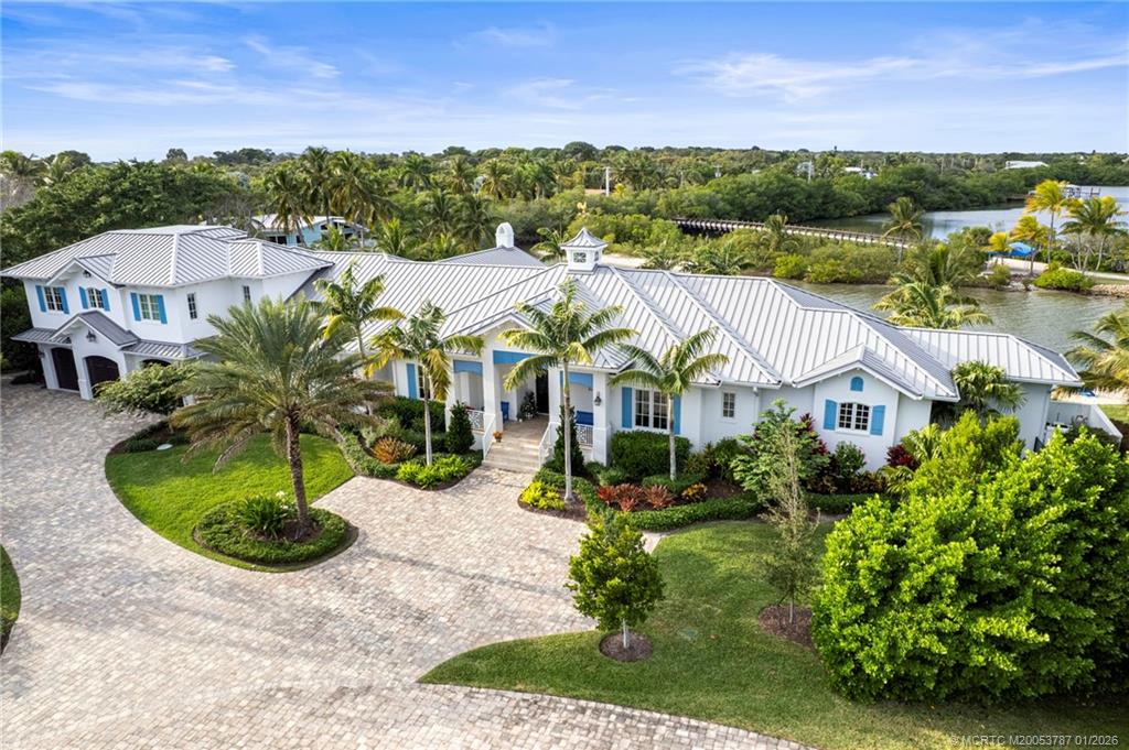 aerial view of a house with a yard and potted plants