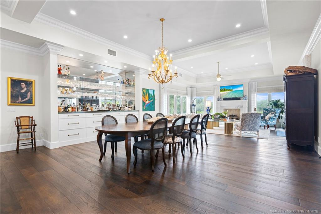 3 Island Road Stuart, FL 34996 - Photo 14 of 58 a view of a dining room and livingroom with furniture wooden floor a chandelier