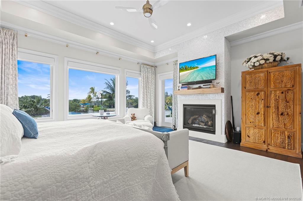3 Island Road Stuart, FL 34996 - Photo 23 of 58 a living room with furniture a fireplace and a flat screen tv