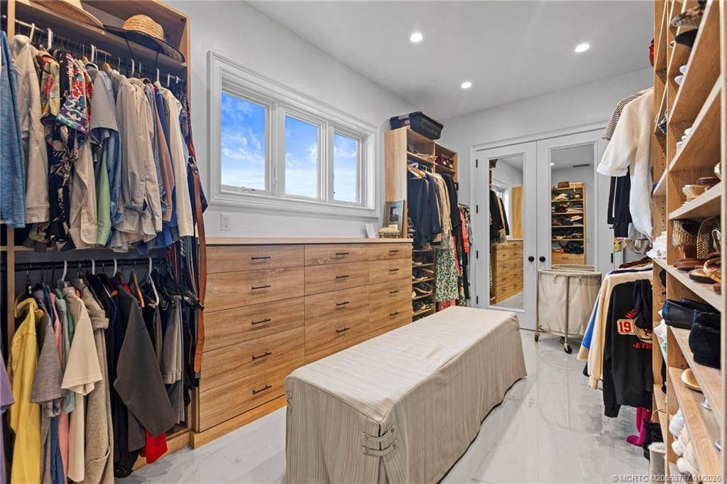 3 Island Road Stuart, FL 34996 - Photo 30 of 58 a view of walk in closet with clothes and shoes